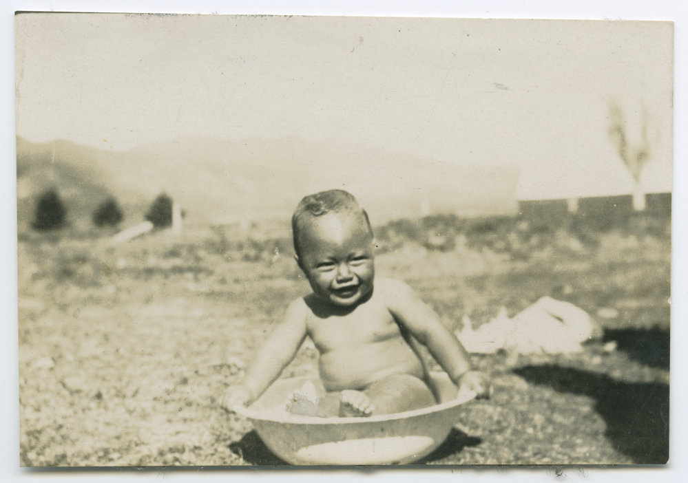 Māori child in a bathing bowl