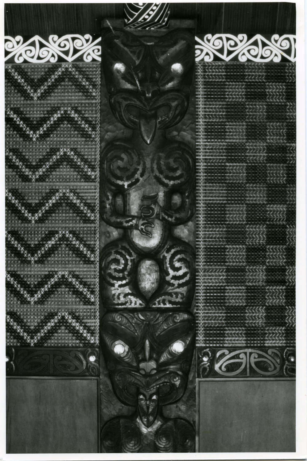 A carved post and tuktuku panels