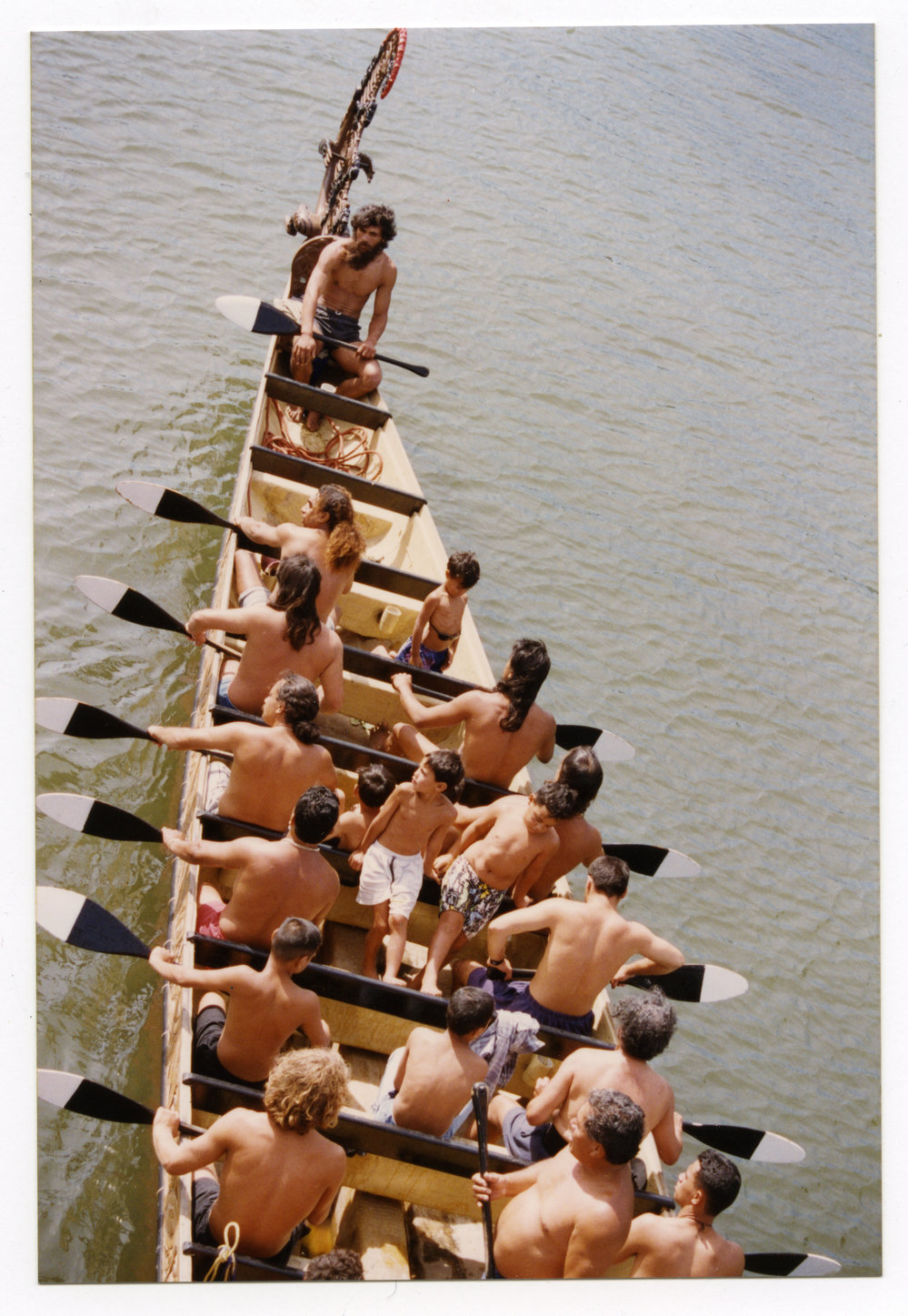 A group of men and boys in a waka | Presbyterian Research Centre