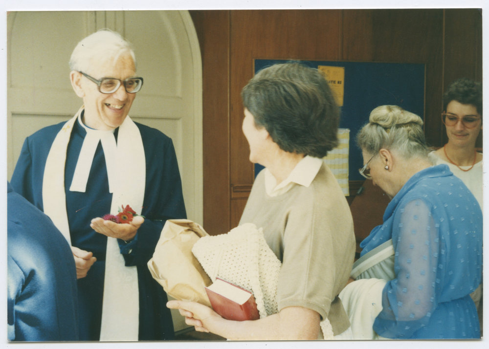 Rev. David Steedman speaking to a woman