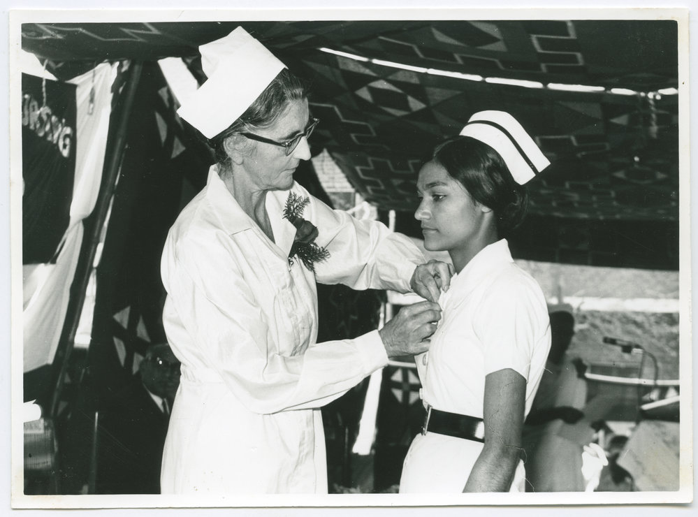 Sister Jean Hanning pins a nursing badge