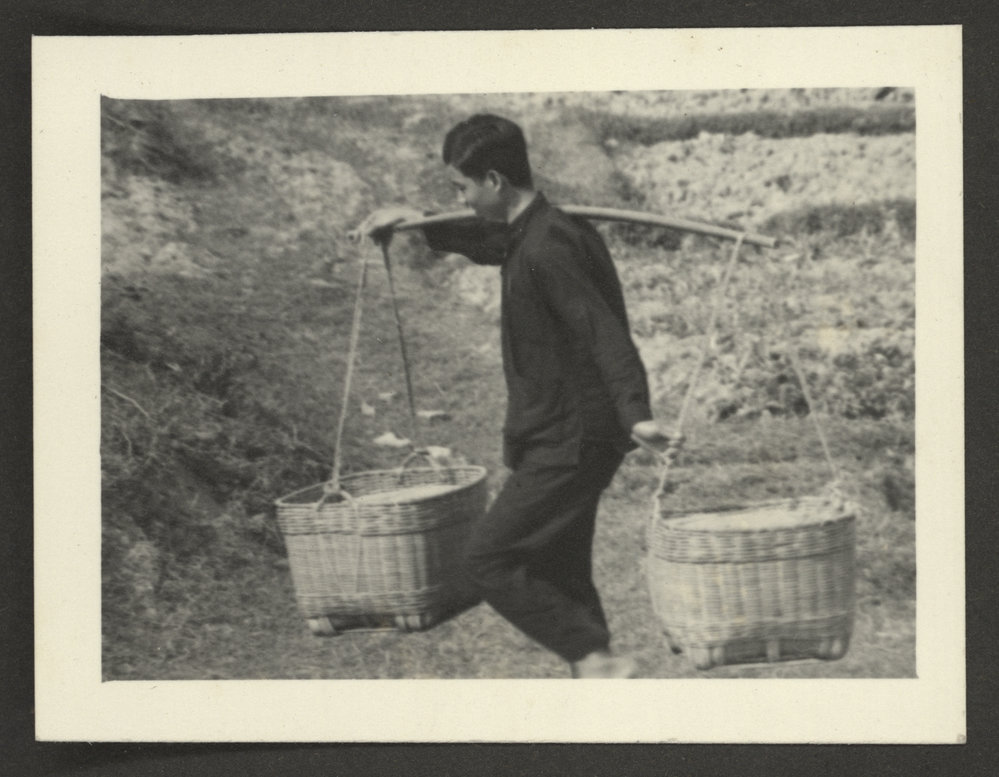 Man Carrying Baskets