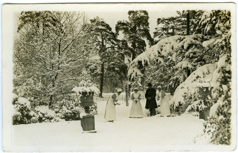 Three nurses and a solider in grounds in snow
