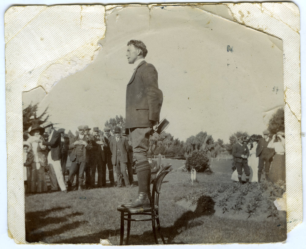 E. J. Tipler preaching or speaking outside [not in uniform], standing on a chair