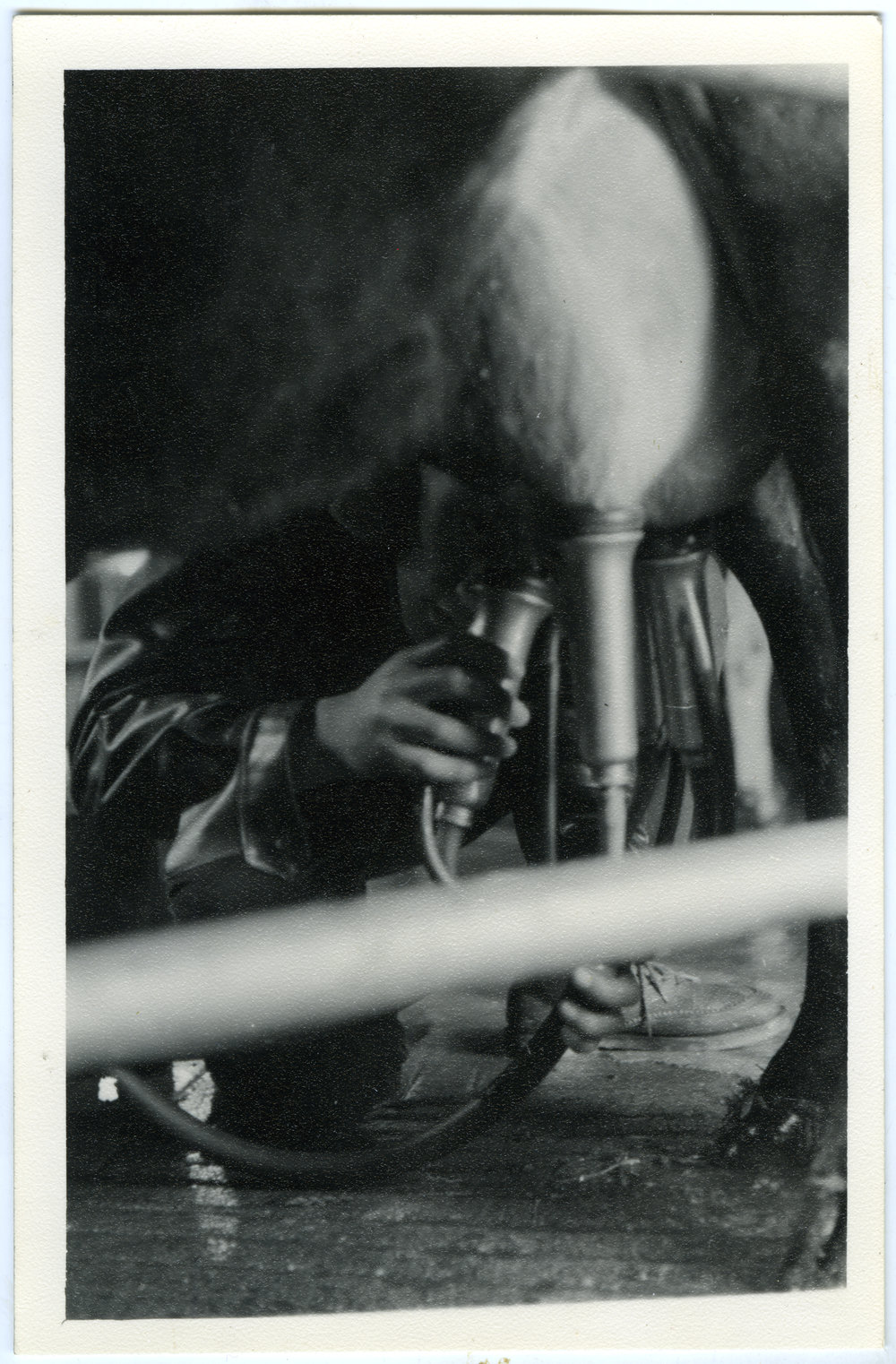 Unknown man milking a cow, 1960