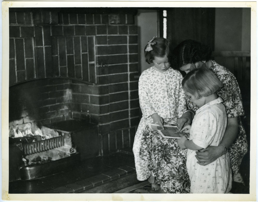 'Storytime is bedtime,' residents of Nisbet Cottage, Glendining Home are read a bedtime story by Miss Halies, 1955