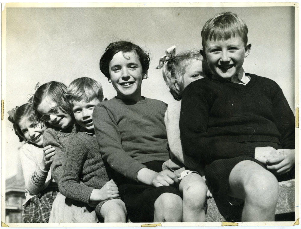 Glendining Home children sitting on a fence, 1955
