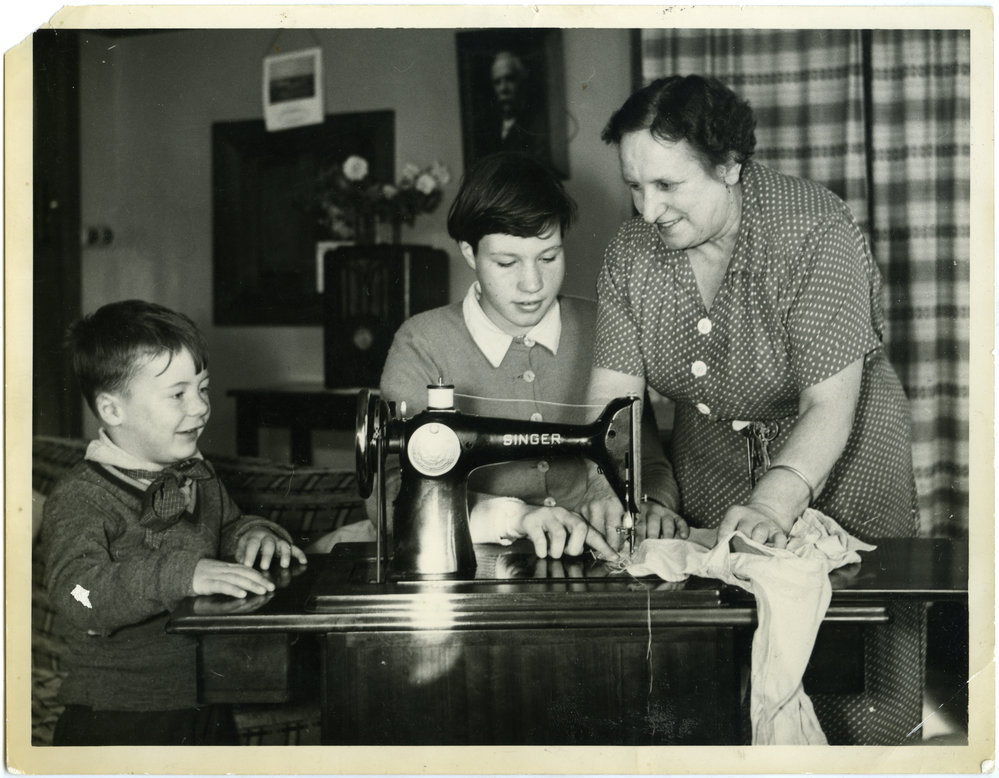 Matron Mrs. E. Mclean helping residents of Cameron Cottage, Glendining Home, sew, 1955