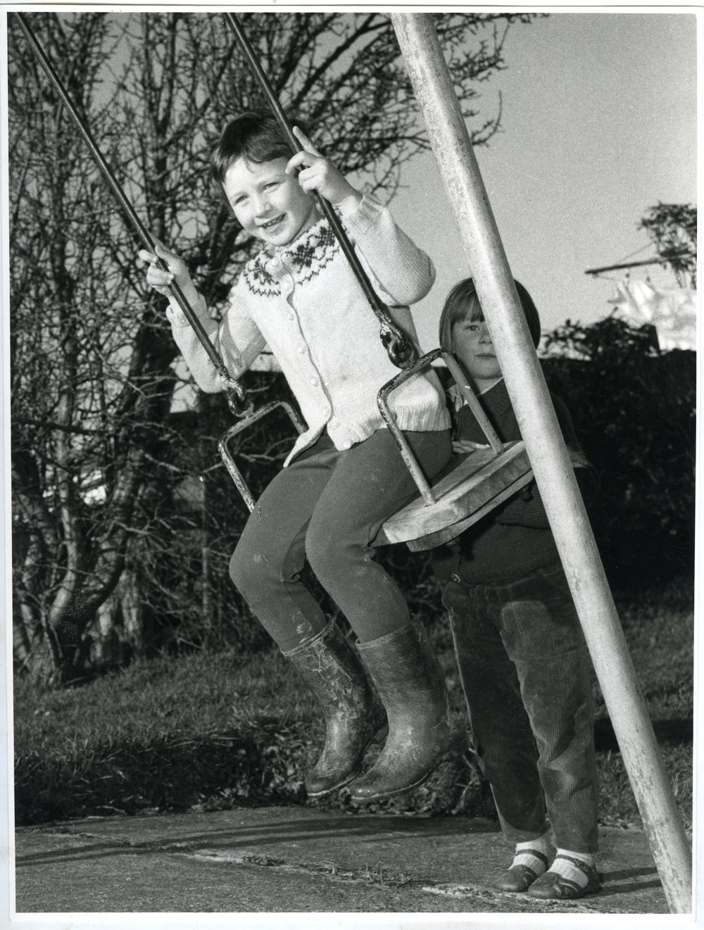 Two unknown girls from Glendining Home playing on the swings, 1968
