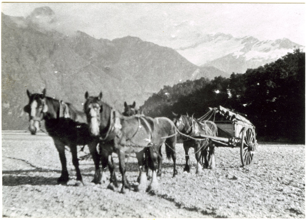 Four horses pull a carriage