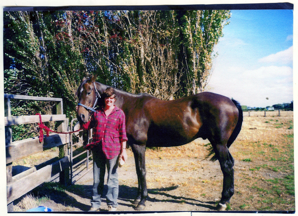 Unidentified woman and a horse