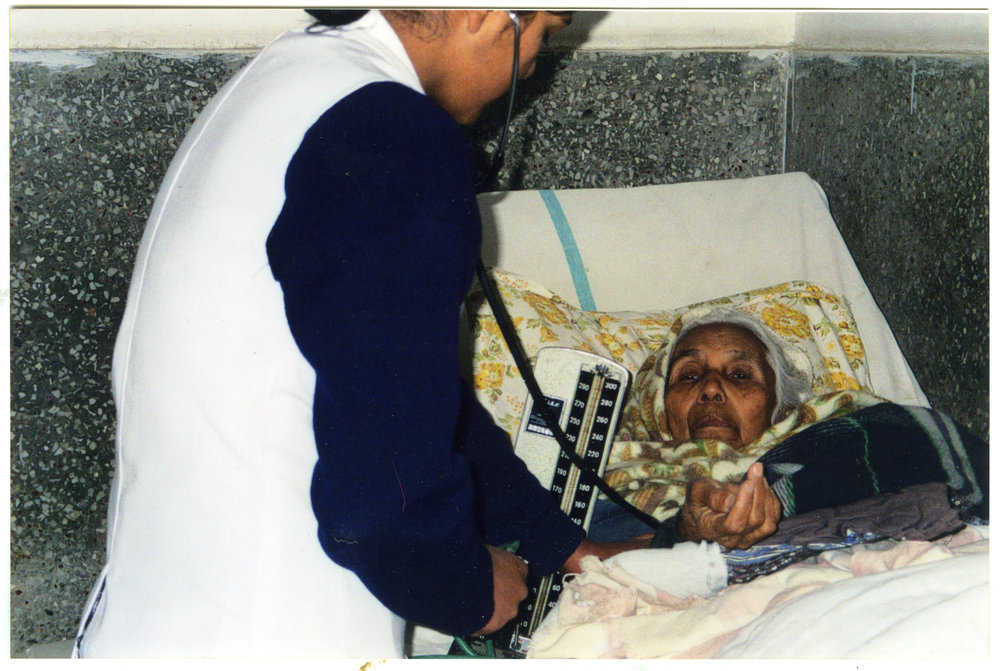 Student nurse takes a patient's blood pressure