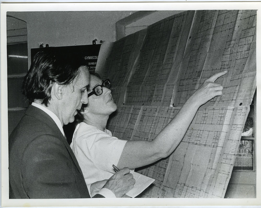 Mr. Cunninghame, High Commissioner for New Zealand making notes while Dr. Beryl Howie explaining the plans of New Obstetrics and Gynaecology Building