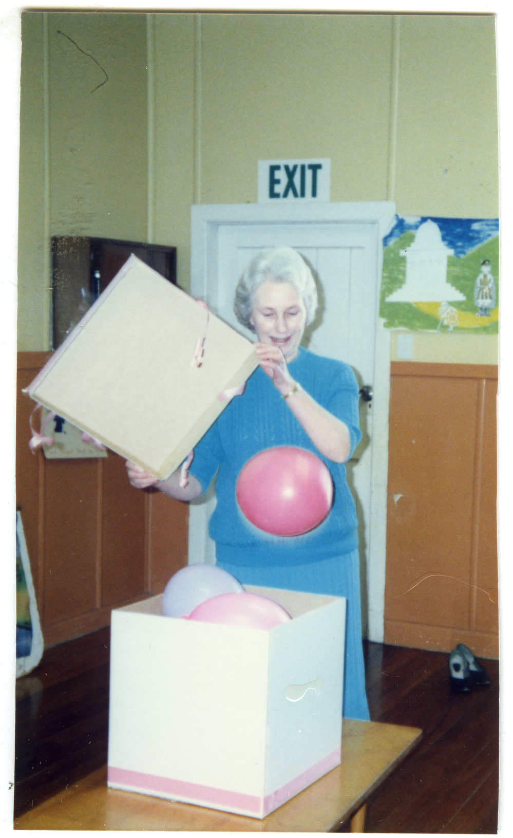 Rosemary Harris opening a box of blue and pink balloons 