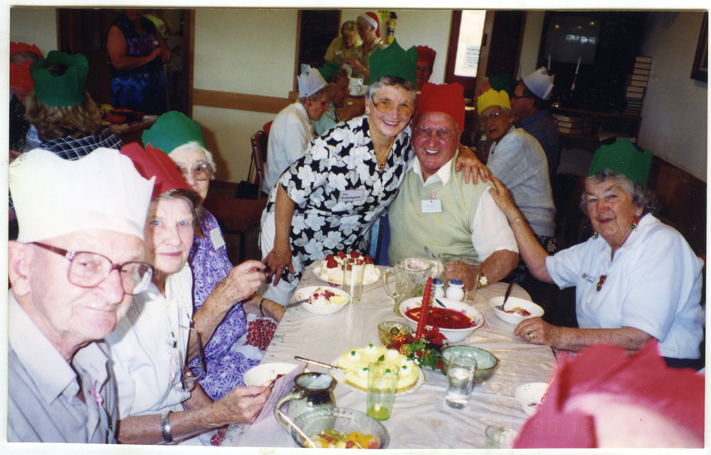 "Friday Lunch, Christmas Feast," Harry Bush gets a hug from Joy Withington, St. Enoch's Church, 1998