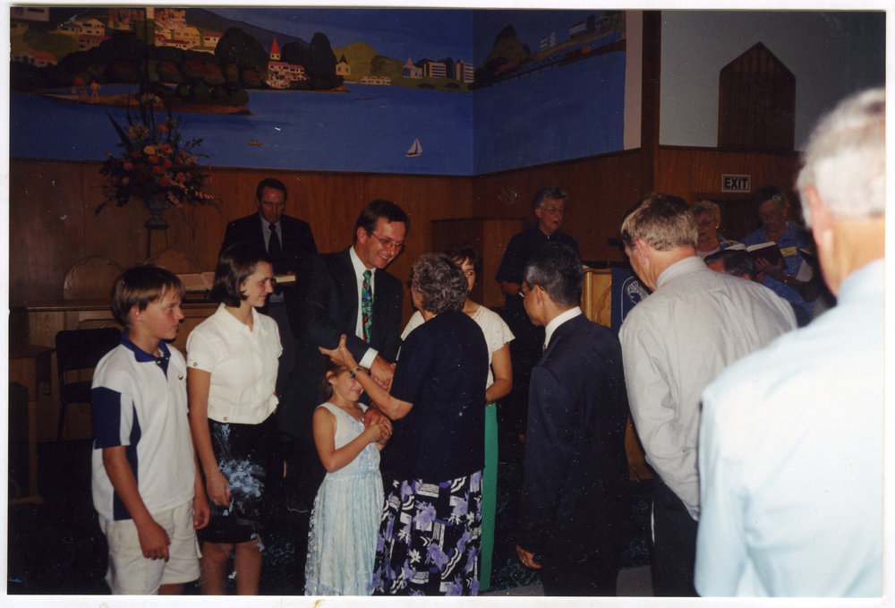 Davey, Elri, Riett, Reverend David and Elna Kriel are welcomed to St. Enoch's Church by Beryl Goodger and others