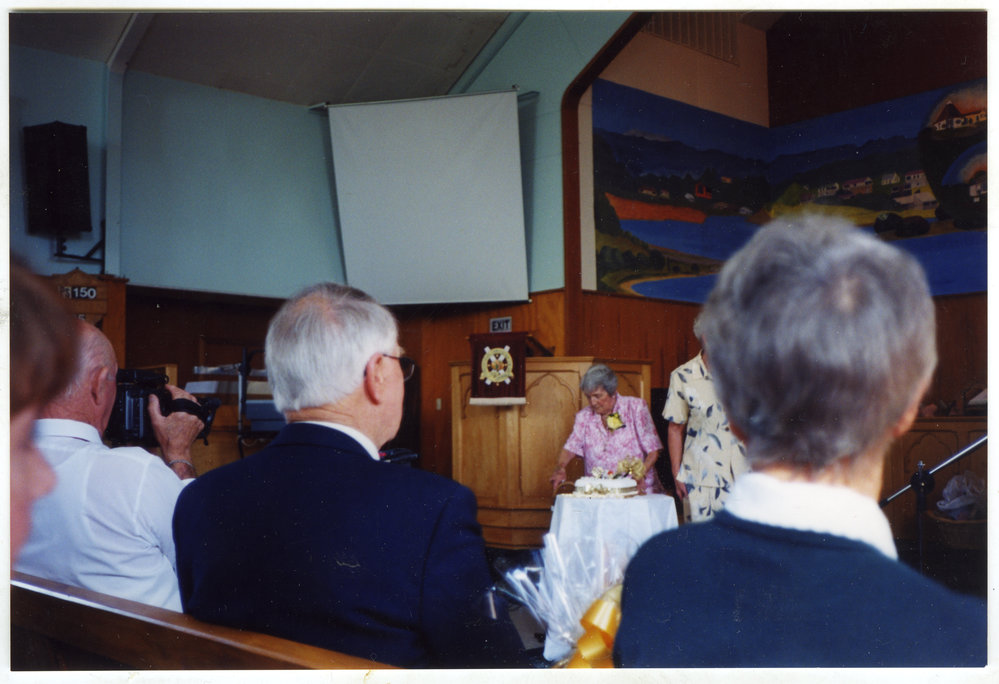 Joan Lodge cutting the cake, St. Enoch's Church
