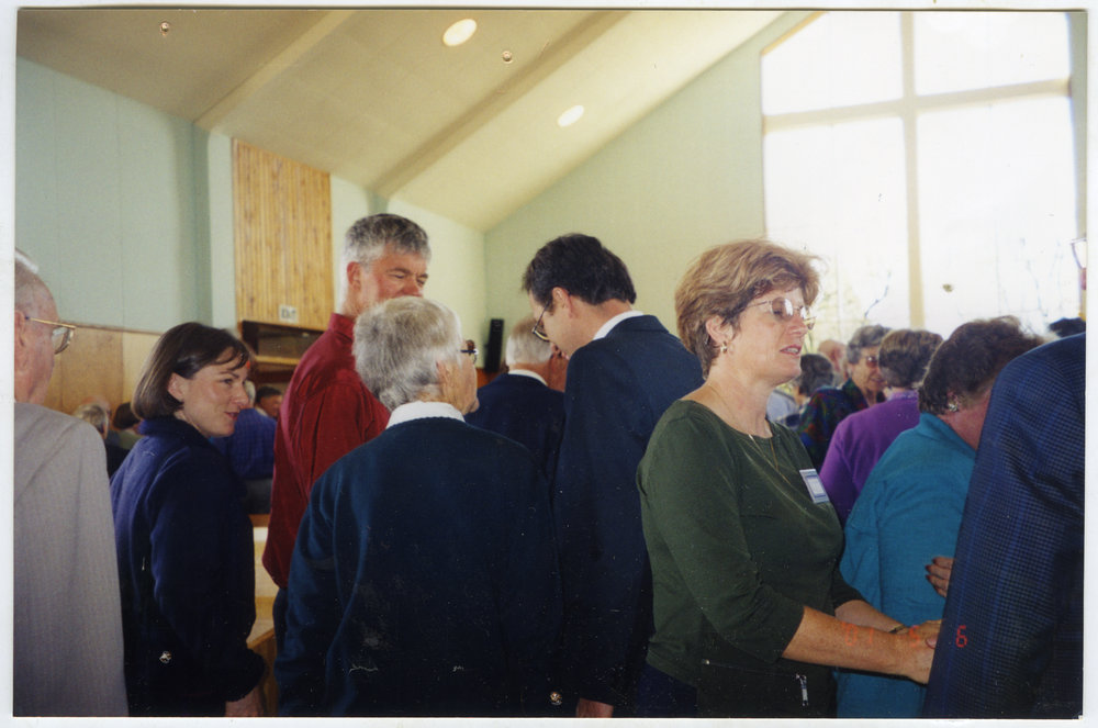 Muir family speaking with Reverend David Kriel, St. Enoch's Church