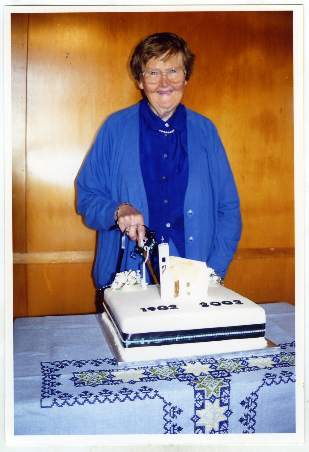 Bernice Mather cuts the 100th Anniversary Cake