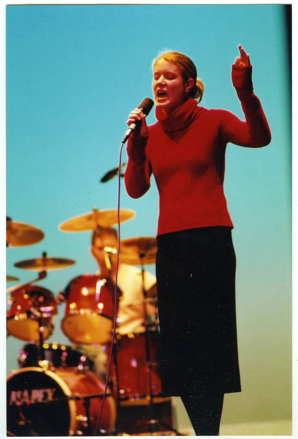 An unidentified young woman sings on stage, General Assembly 2002