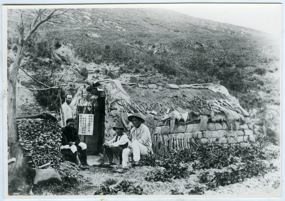 Reverend Alexander Don and three Chinese men seated around a clay brick dwelling