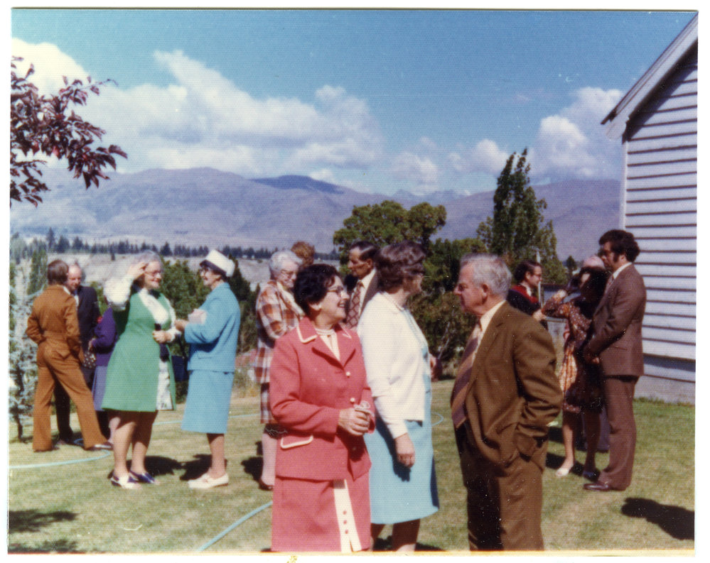 Unidentified adults talk after a service at Cromwell Church