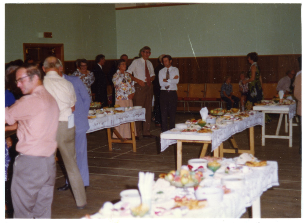 Parishioners of Cromwell Church enjoy refreshments in a school gymnasium 