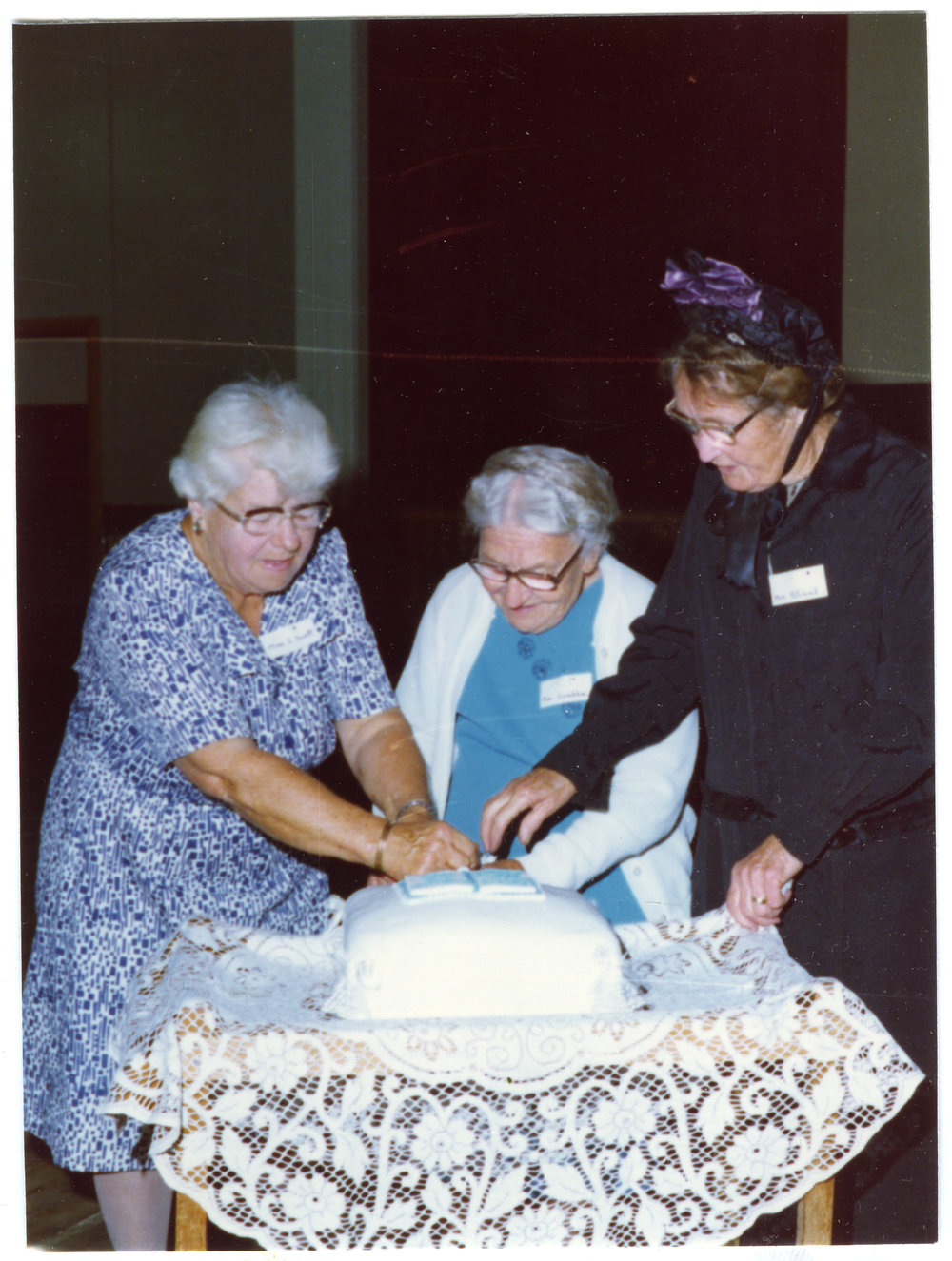 Three women cut the 100th anniversary cake for Cromwell Church