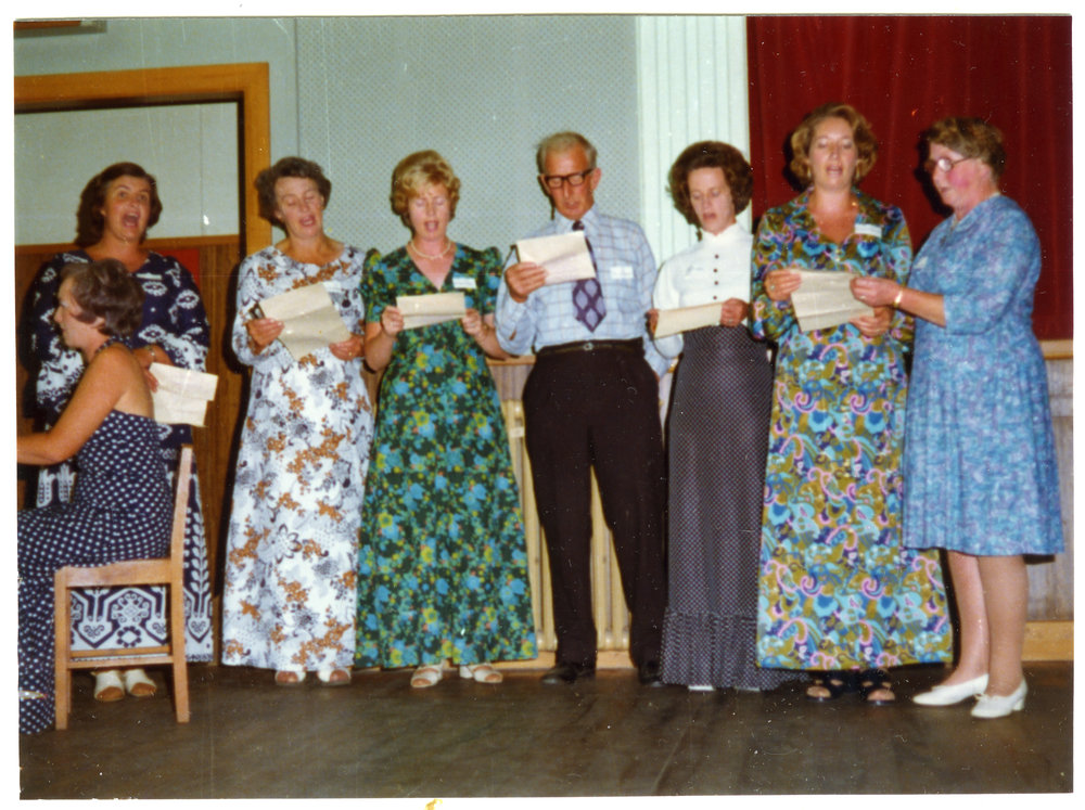 Women and a man belonging to Cromwell Church perform a song, a woman plays the piano