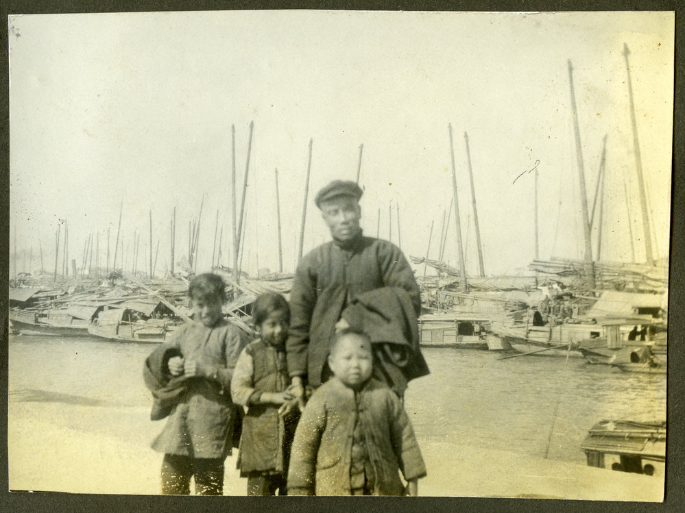 "Boatman," Unidentified Chinese man with three unidentified Chinese children