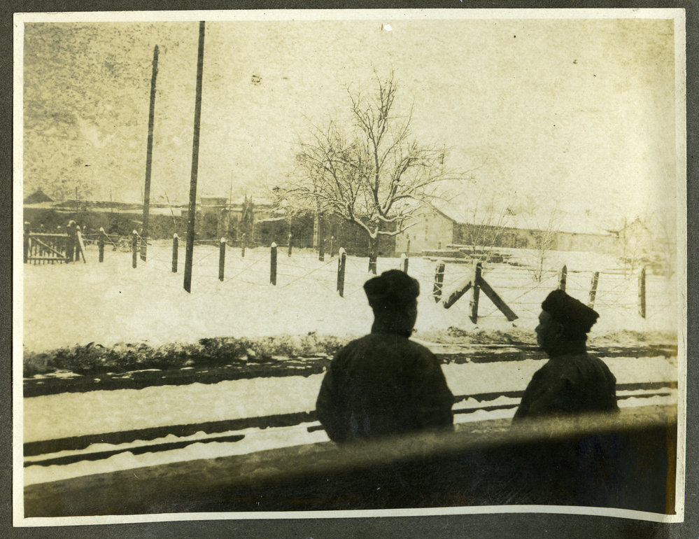 "Mukden," two unidentified men standing next to a railway station