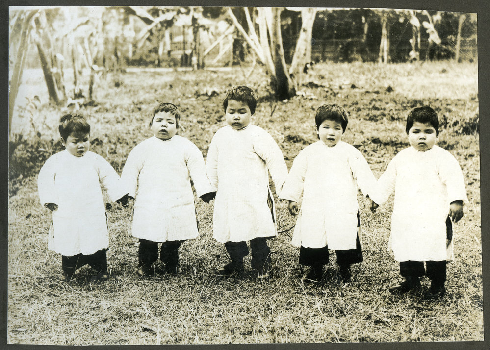 Five blind girls, from the Chins Sam School for Rescued Blind Slave Girls, are holding hands