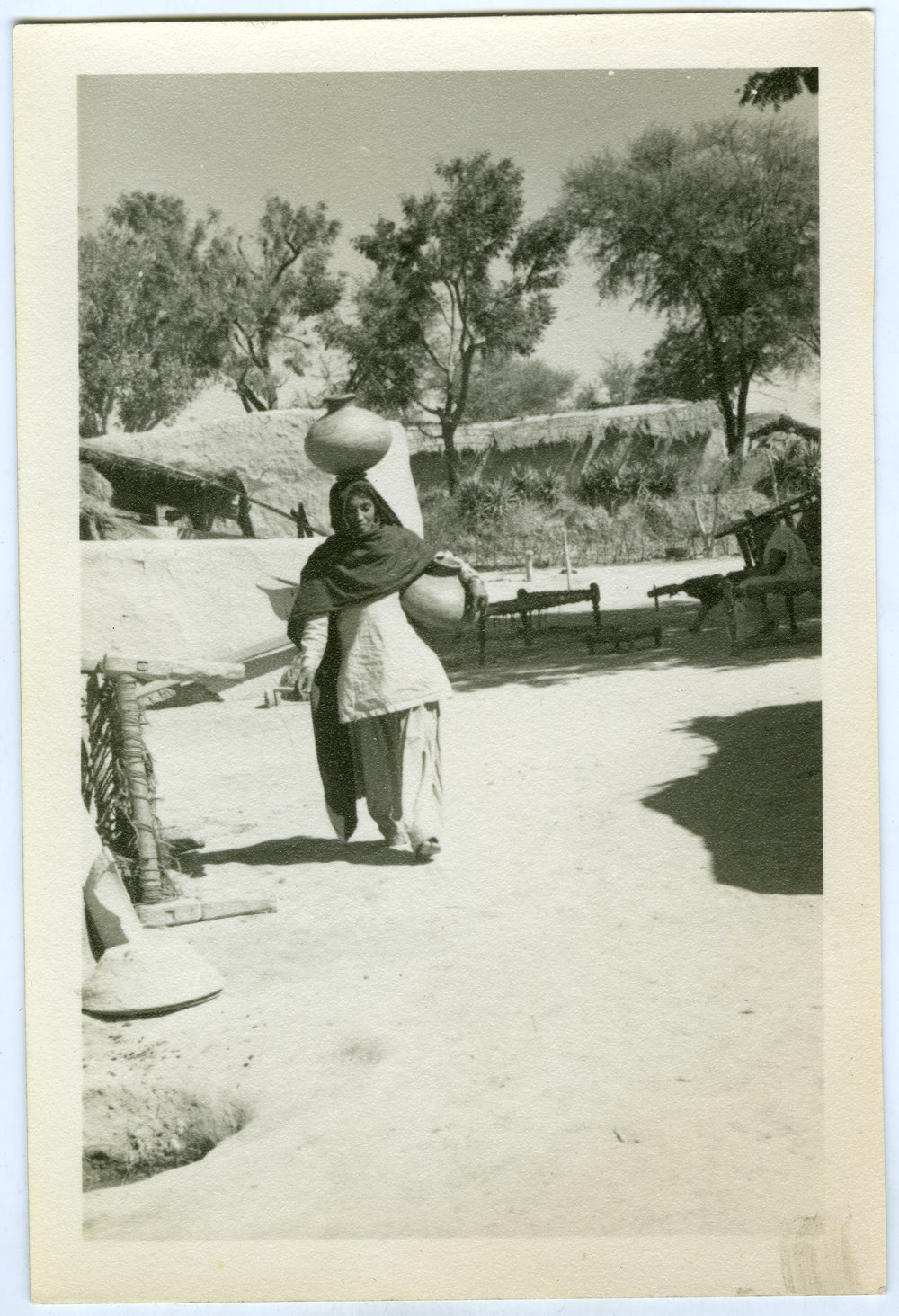 Unidentified village women carrying water