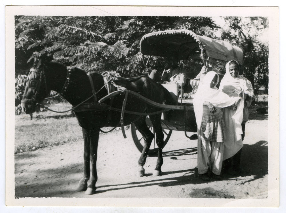 The unidentified women who accompany the town girls to school