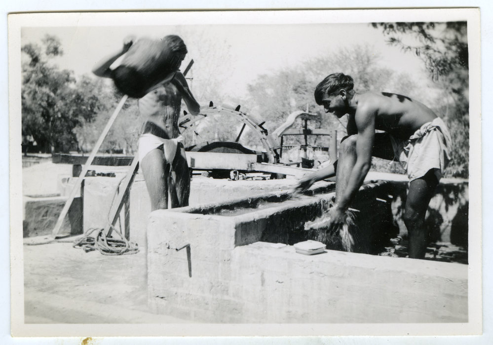 Unidentified men washing in the outdoors