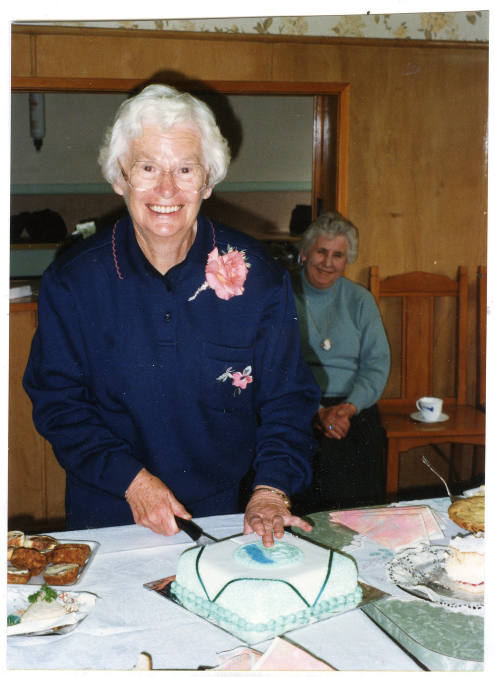 Peggy Weir cutting cake for the fourth anniversary for St. Columba's walking group, 1995