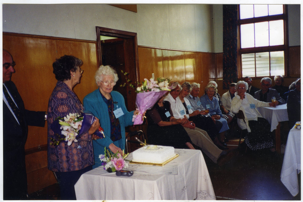 Muriel Aldridge and M. Howie cutting cake, St, Columba.