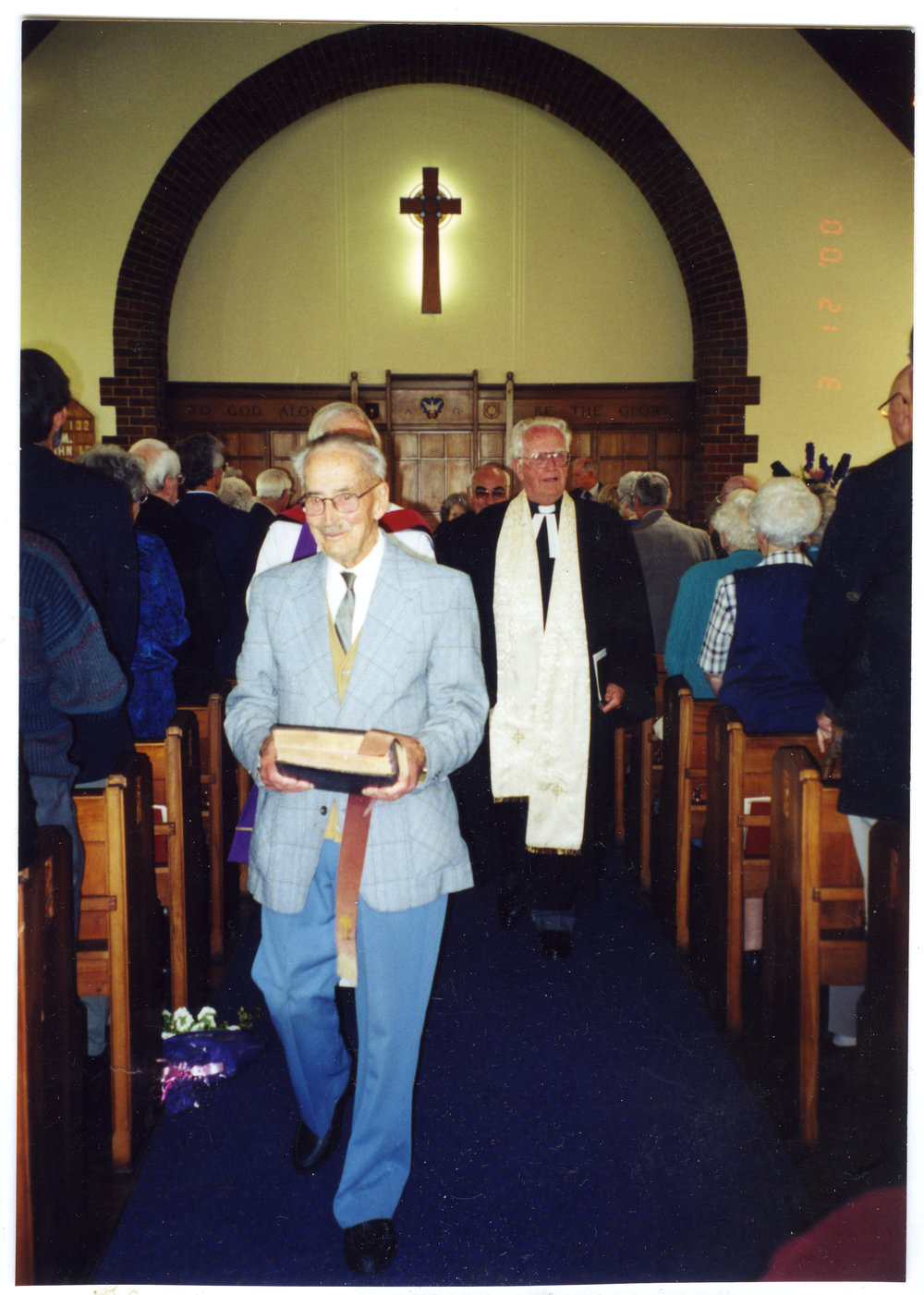 Ian McBride and H. Mawson walk down the aisle at St. Columba after a service. 