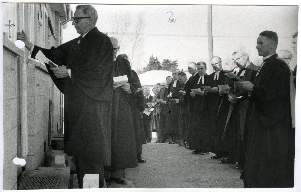 C. C. Wilson is knocking at the door, while A. Baxter looks on, during the opening of Burwood United Church