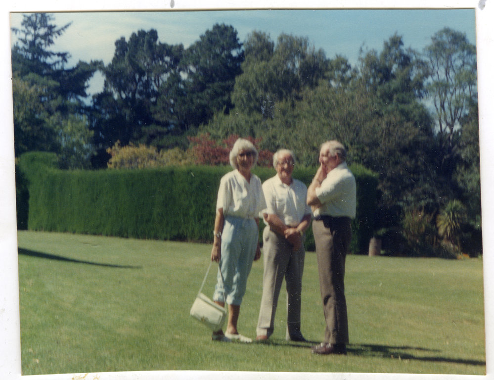 Jean Van der Luig and husband are standing with the host of Ford Milton Home, 1986