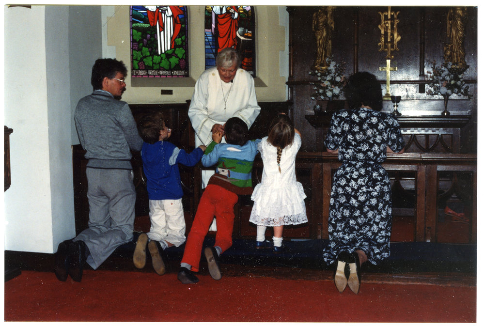 Unidentified family receiving Communion