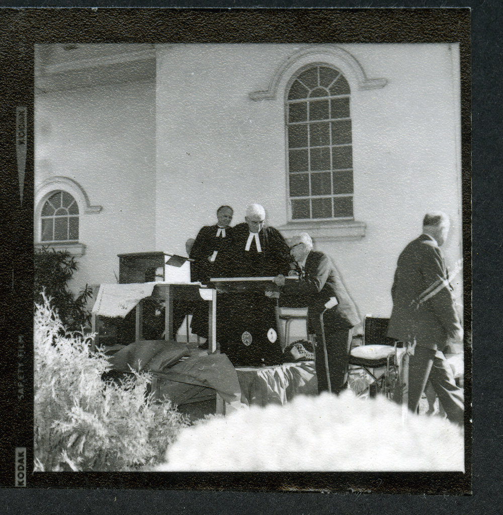 Unidentified man standing at a podium, talking to another unidentified man, John Knox, Rangiora, 1972