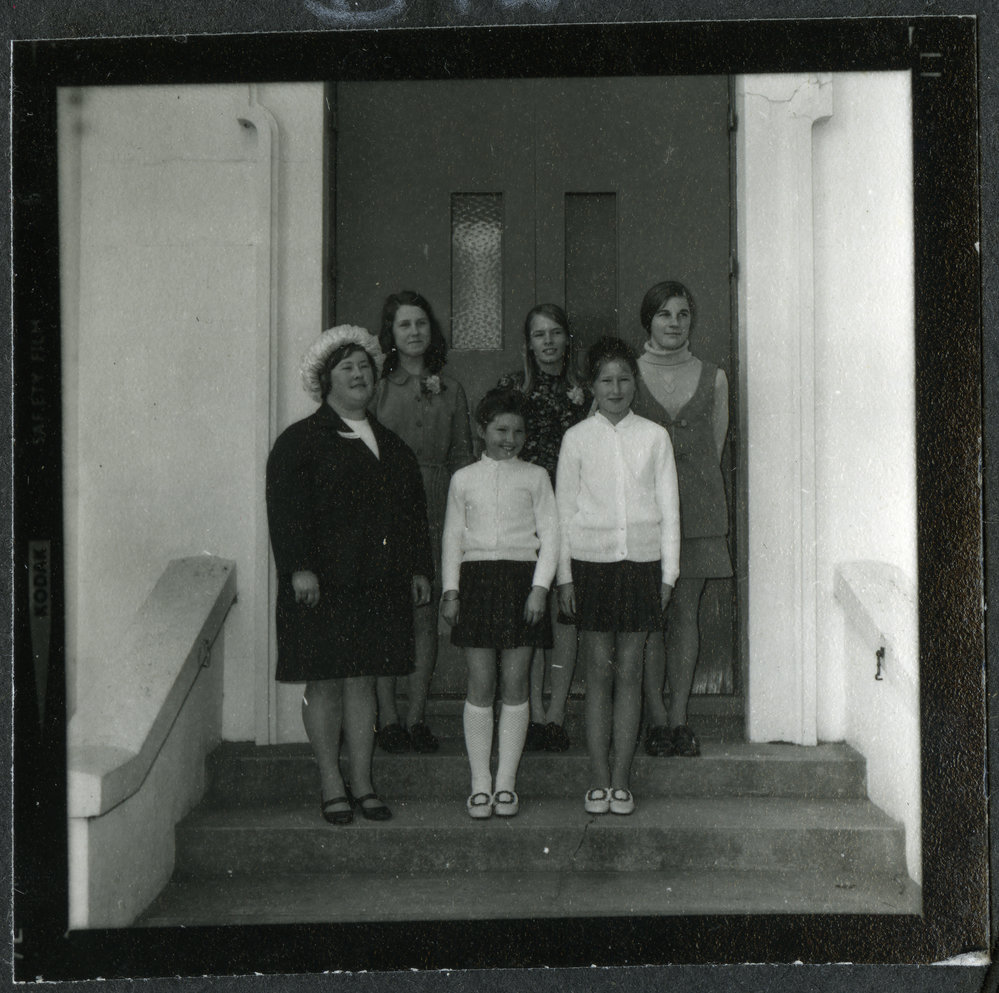 Six unidentified young girls stand at the steps of John Knox Church, 1972