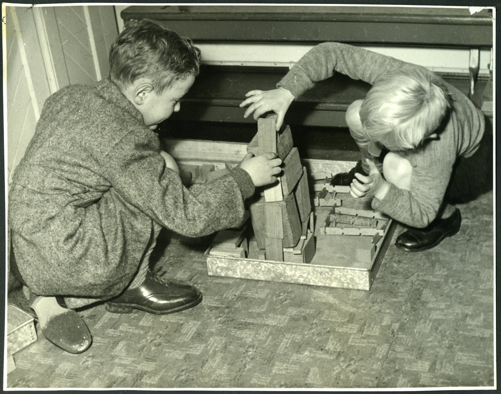 Two unidentified boys playing with blocks