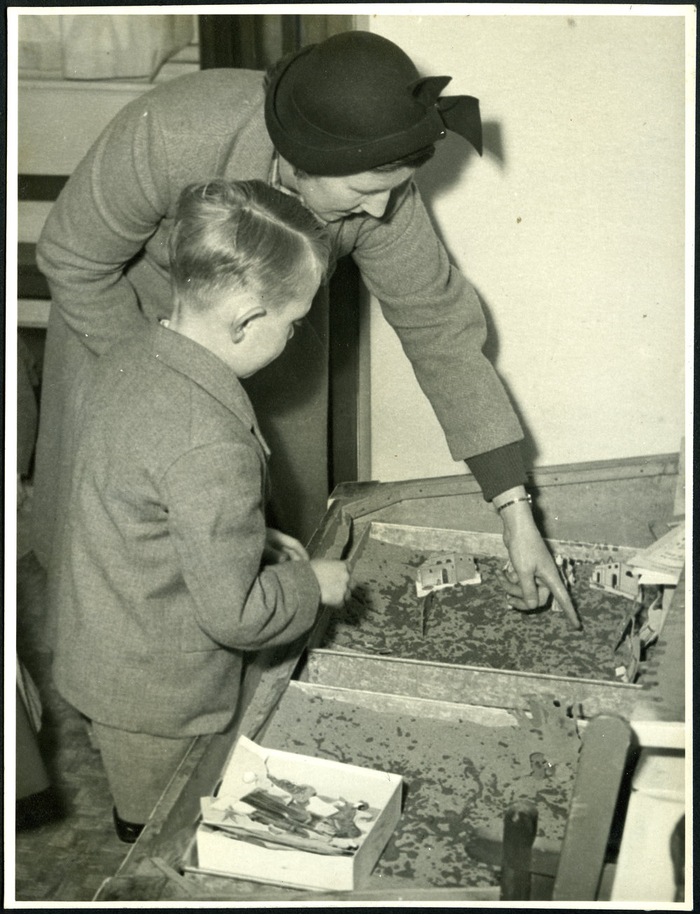 Unidentified woman playing with unidentified boy