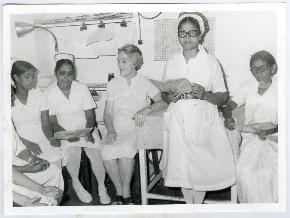 Beryl Howie is seated with unidentified nurses, Ludhiana