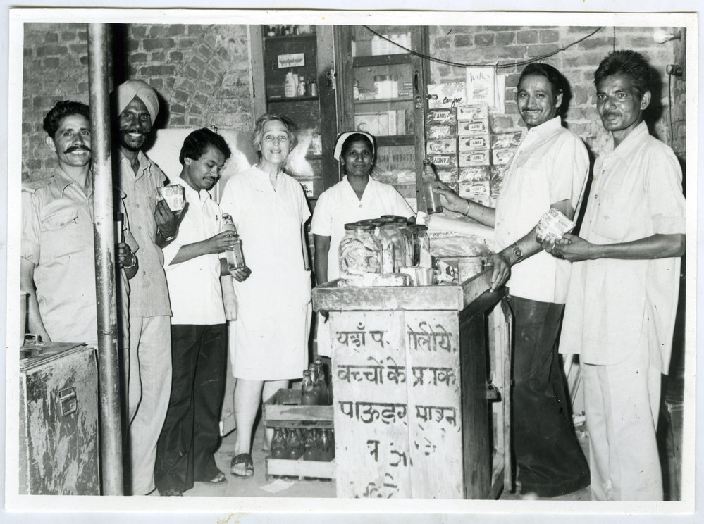 Beryl Howie and five unidentified Indian men and one woman, who are enjoying a beverage and a snack, Ludhiana