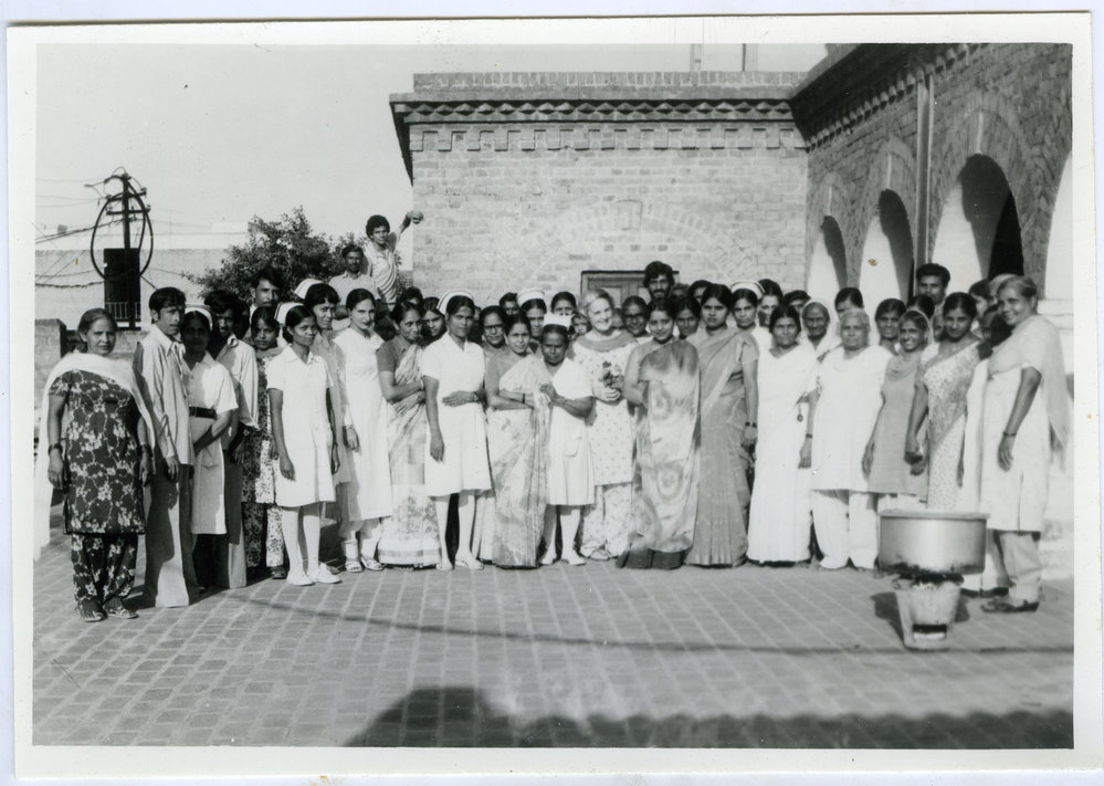 Large group photograph of Beryl Howie (centre) with staff and patients of the Christian Medical College and Hospital, Ludhiana