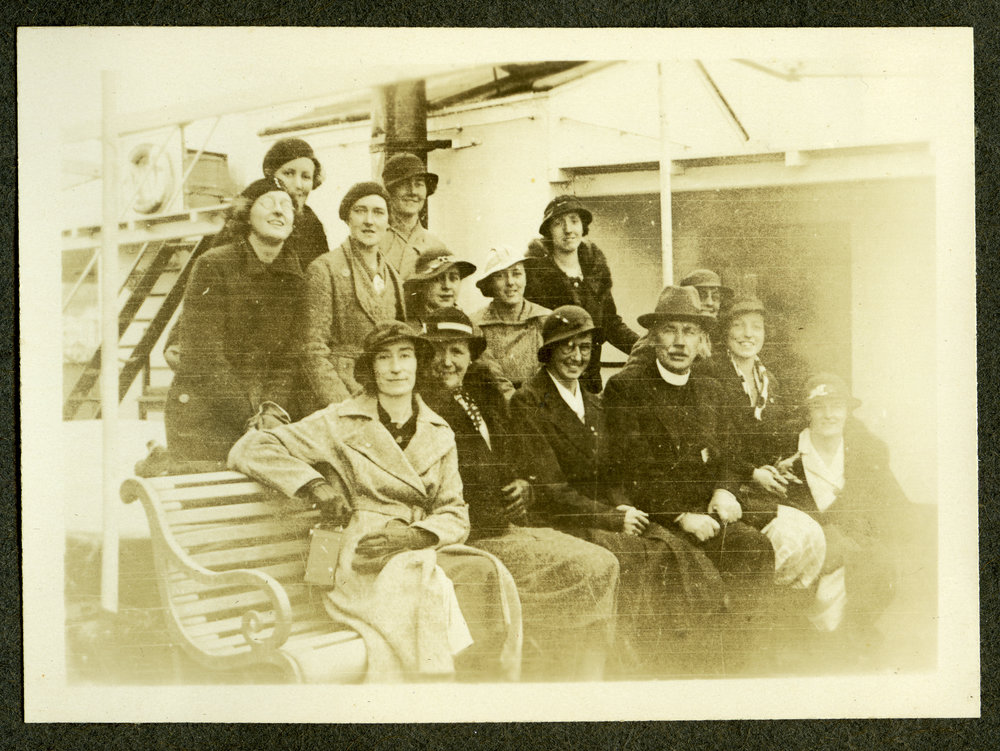 Lorraine E. Saunders, and unidentified minister and woman stand on board a vessel to India
