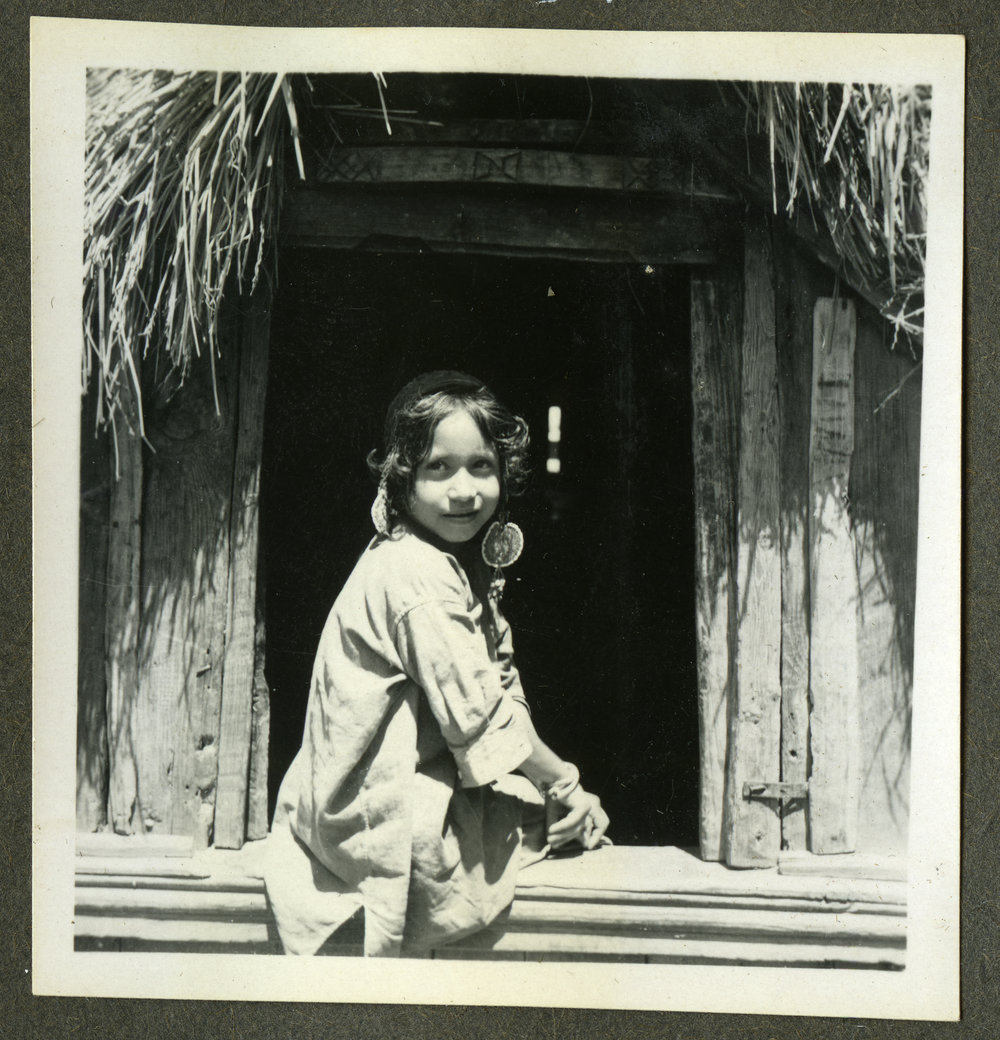 "Kashmiri Types," a young girl rests on a window ledge